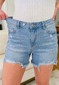Asymmetric Raw Hem Distressed
Whiskery Denim Shorts