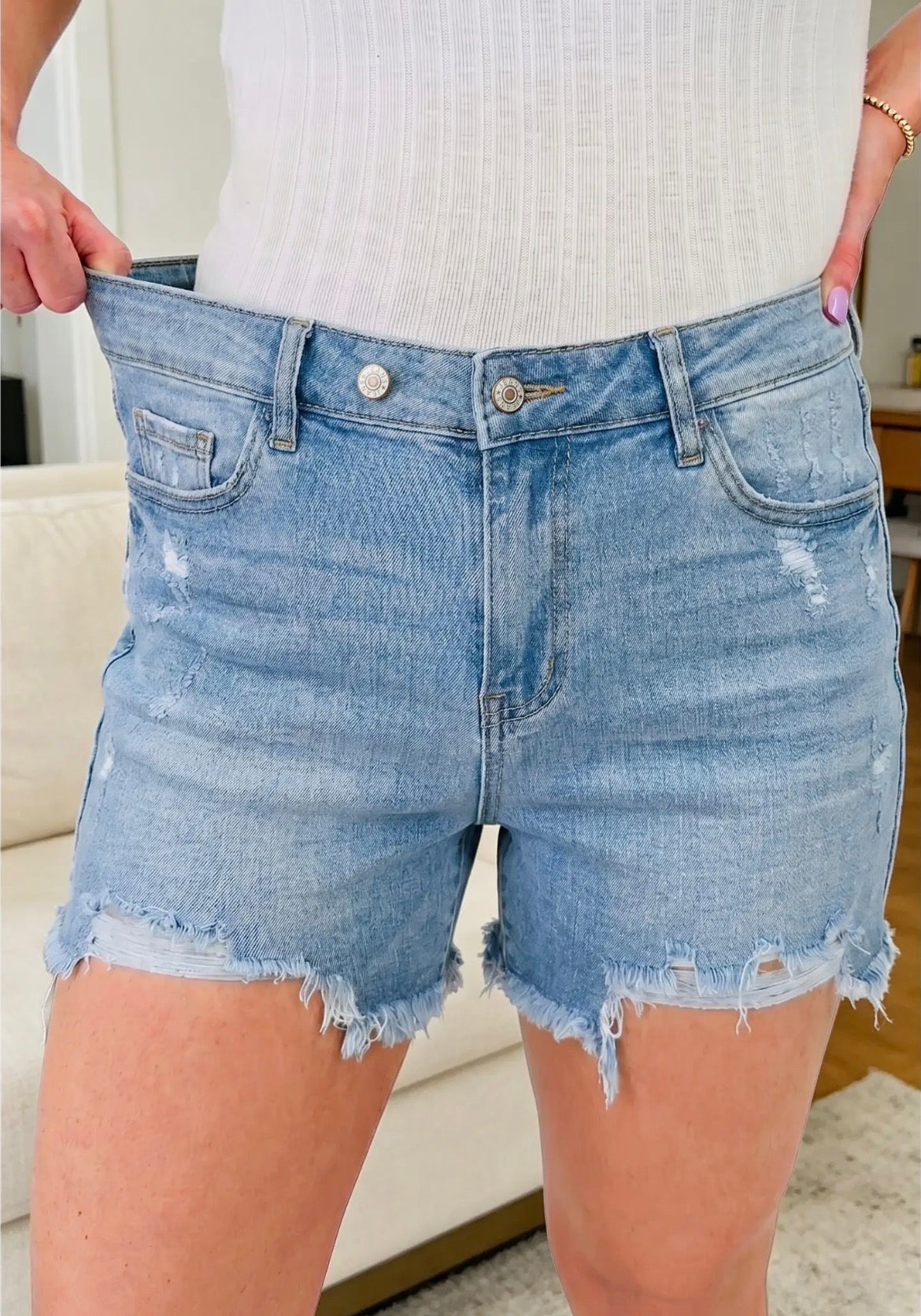 Asymmetric Raw Hem Distressed
Whiskery Denim Shorts